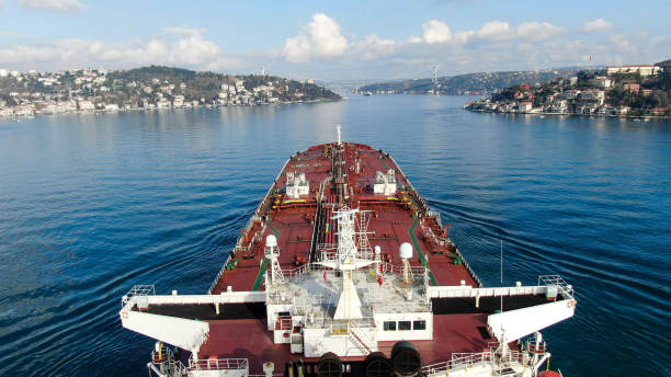 Aerial evening view of a vessel with illuminated maritime operations under a twilight sky.